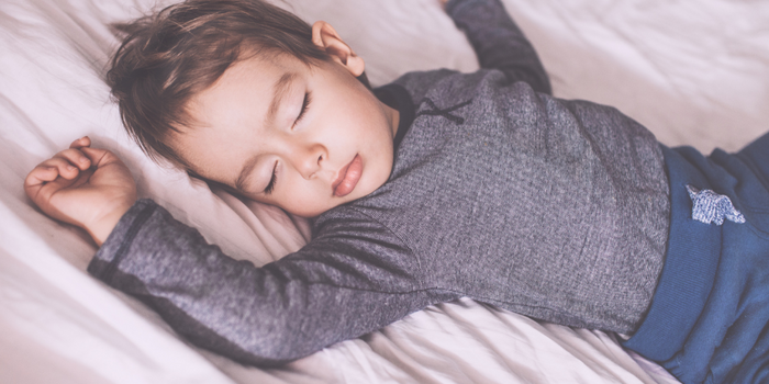 Toddler looking out over top of cot