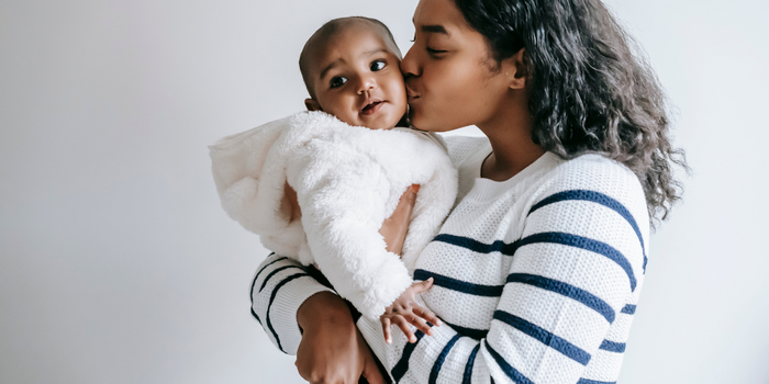 A woman holding a sleeping baby