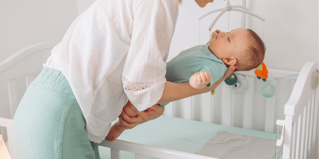 Newborn baby asleep in crib