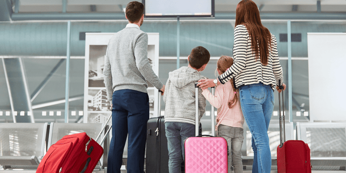 Family walking through airport